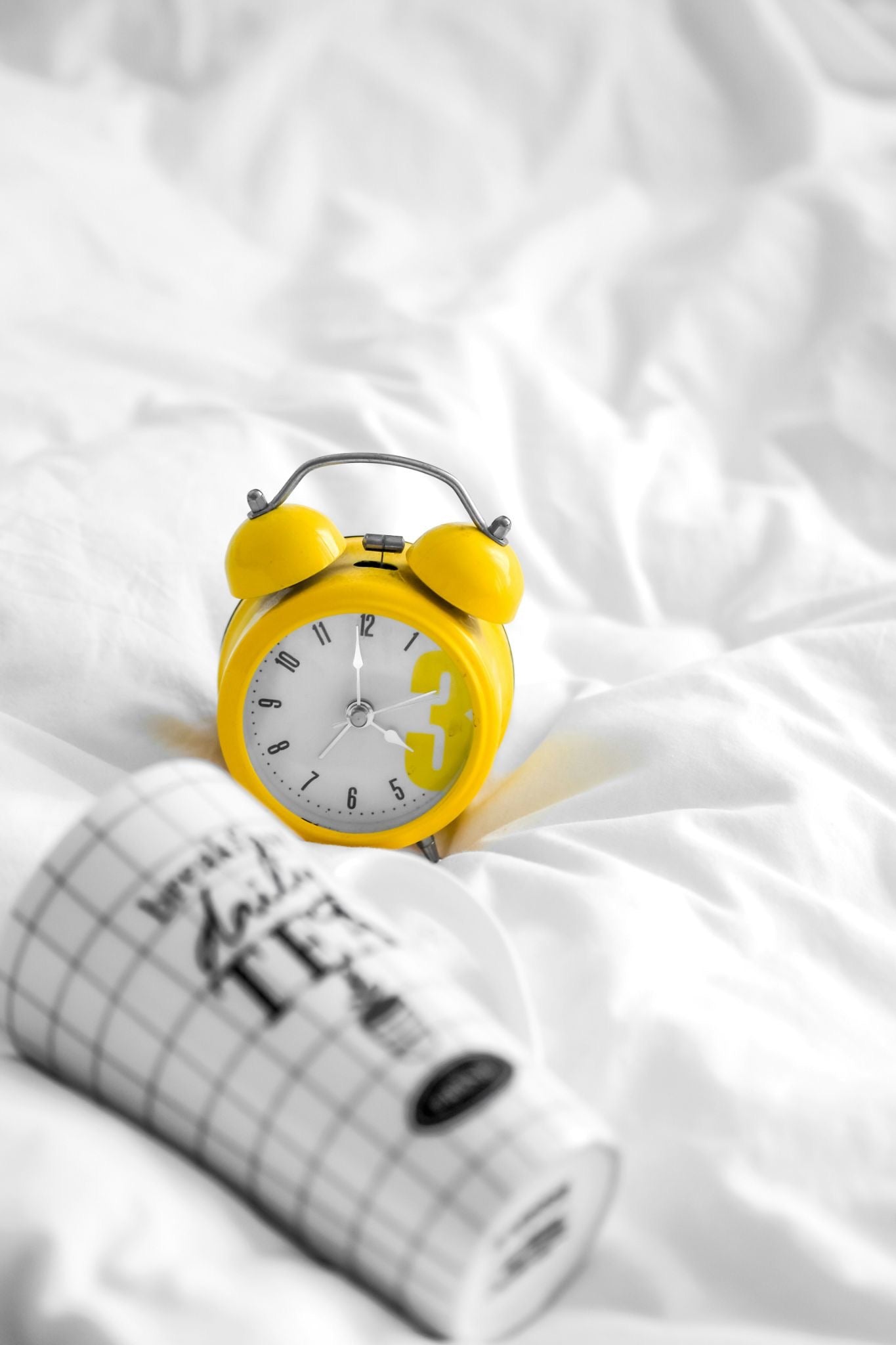 yellow clock on the bed