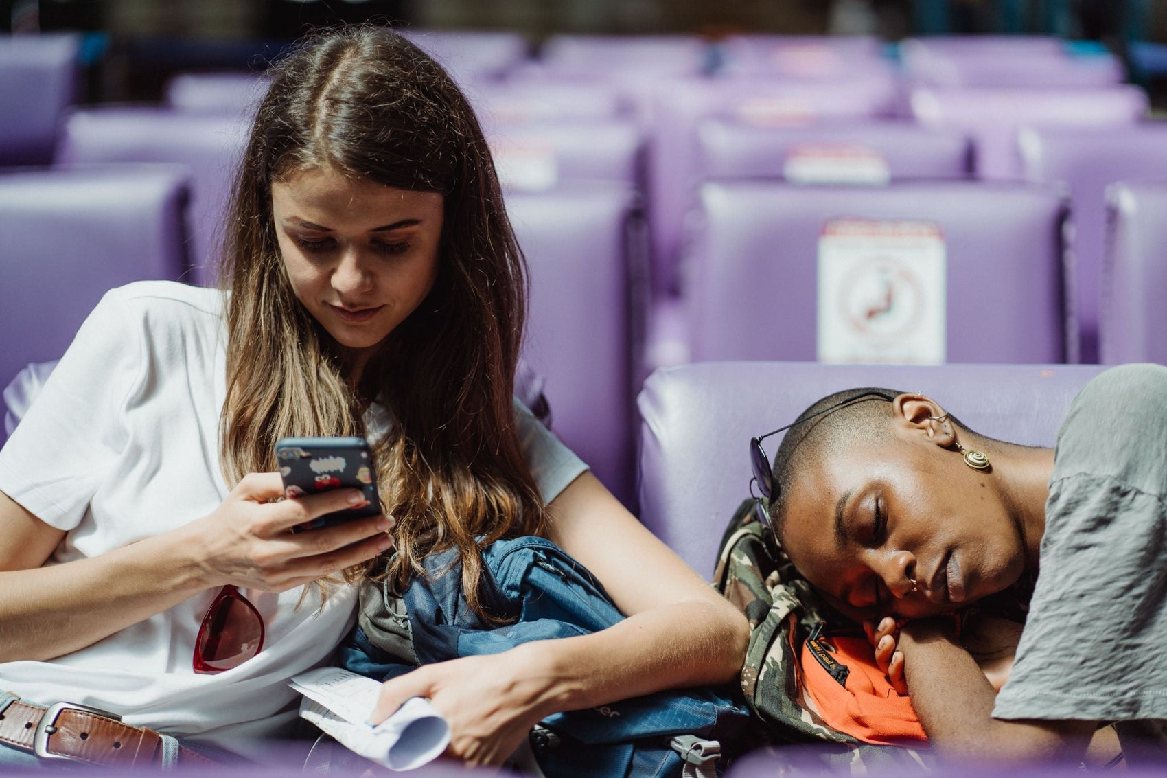 two young women and one is sleeping 