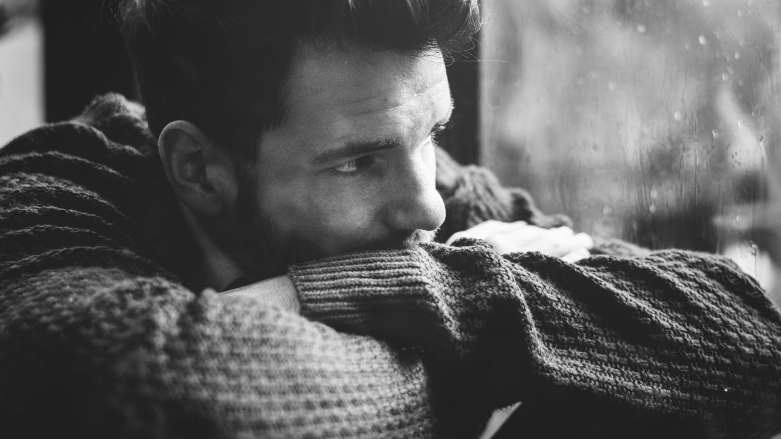 man looking out the window